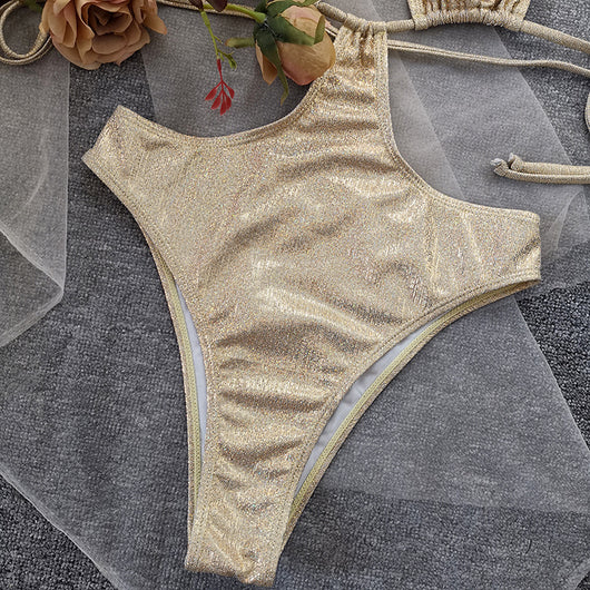 Woman wearing a shimmering gold one-piece swimsuit with a halter neck, crisscross straps, and stylish cut-out details. - Image 18