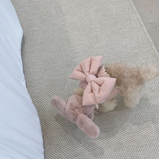 Creamy-white plush dog harness with a large decorative bow on the back, worn by a small poodle-like dog. - Image 2
