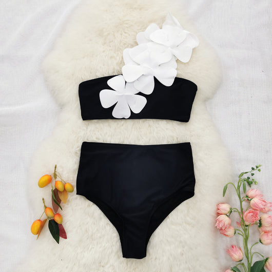 Women's black one-shoulder two-piece swimsuit with large white floral appliques and high-waisted bottoms. - Image 10