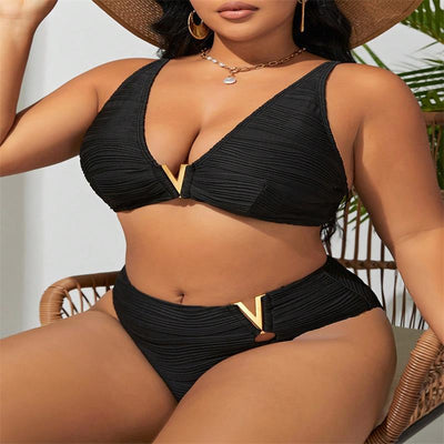 Plus size woman in a black textured two-piece bikini with gold V-shaped hardware. The top is a plunge style, and the bottoms are high-waisted. - Image 3