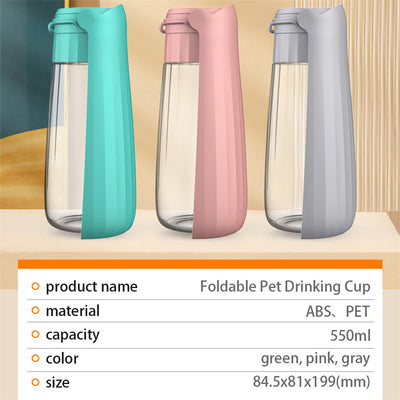 Yellow 450ml portable pet water bottle with a folding drinking trough and white wrist strap, on grass. - Image 19