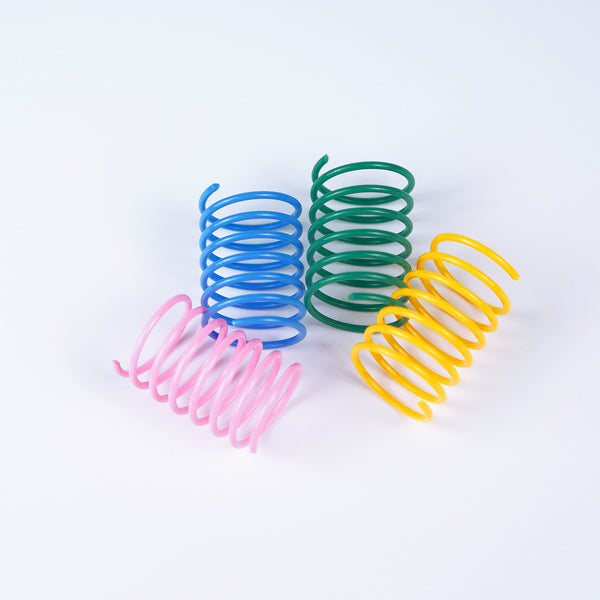Four colorful plastic spring cat toys in blue, green, yellow, and pink on a white background.