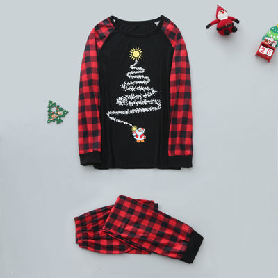 Family of five wearing matching black and red buffalo plaid Christmas pajamas with a white Christmas tree print. - Image 8
