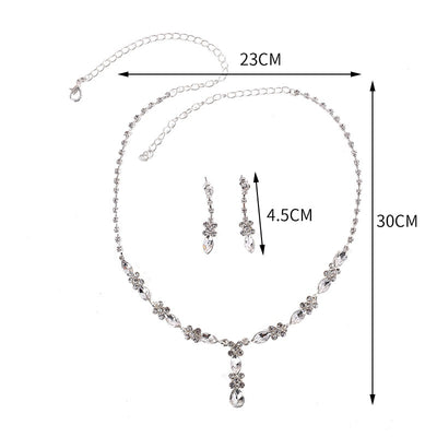 Elegant silver-tone necklace and matching drop earrings set with clear marquise and teardrop stones, displayed on a black bust. - Image 6