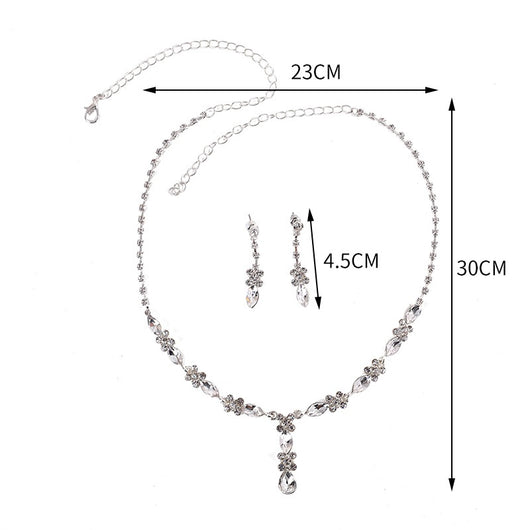 Elegant silver-tone necklace and matching drop earrings set with clear marquise and teardrop stones, displayed on a black bust. - Image 6