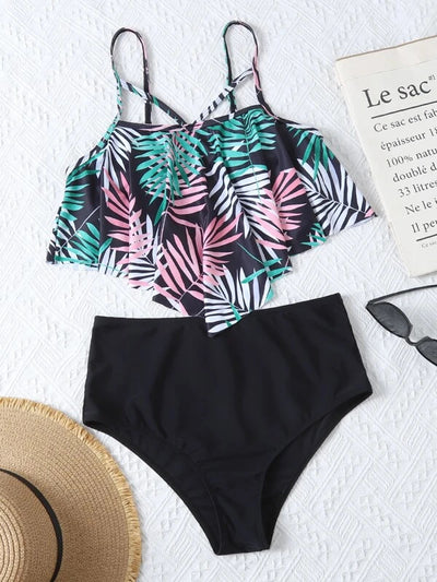 Women's split swimsuit with a black high-waisted bikini bottom and a flounced tankini top featuring a green, blue, and white tropical leaf print. - Image 22