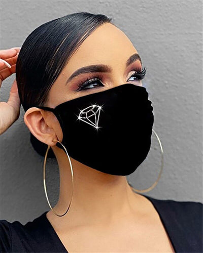 Black cotton face mask with a rhinestone flower design and "Be Kind" in pink rhinestones, worn by a person. - Image 11