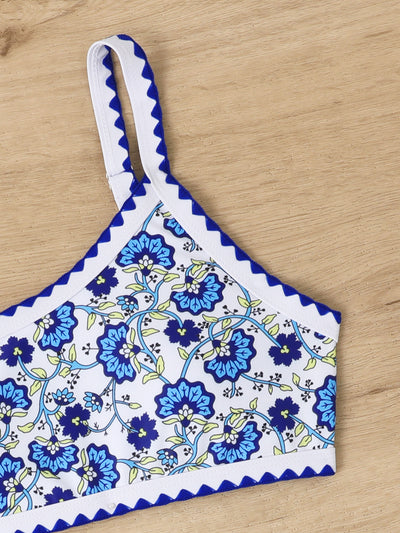 Women's one-shoulder bikini with red and blue floral print on white, featuring red trim and tie-side bottoms. - Image 18