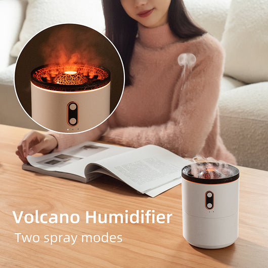 White volcanic flame aroma essential oil diffuser emitting orange light and mist on a wooden desk next to a laptop. - Image 4