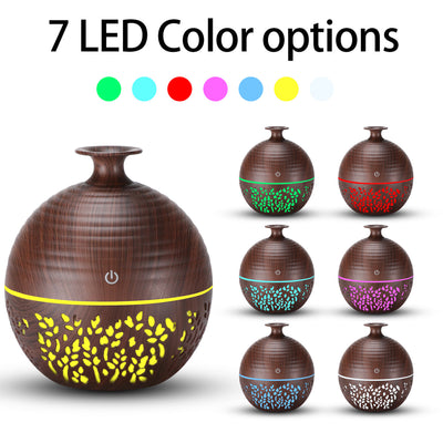 Light wood grain portable mini aroma diffuser humidifier with a vase shape and glowing blue leaf patterns. - Image 3