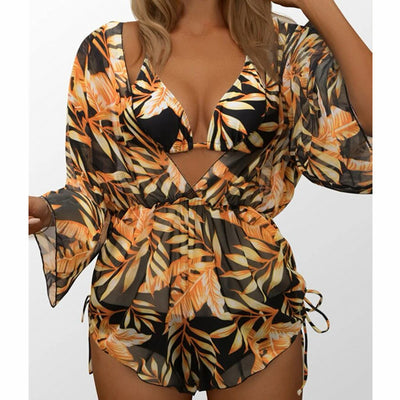 Woman wearing a white and black tie-dye beach cover-up romper with a deep V-neck and drawstring sides. - Image 6