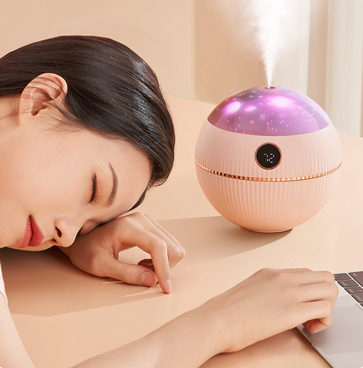 Pink spherical humidifier with a white top, ribbed texture, rose gold band, and a digital display showing 73%. - Image 14