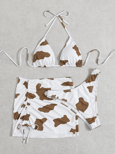 Women's three-piece cow print swimsuit with a white and brown triangle bikini top and a ruched mini skirt. - Image 9