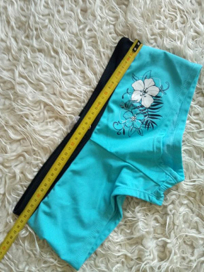 Black halter bikini suit with boy short bottoms, featuring pink and blue floral and flamingo patterns. - Image 11