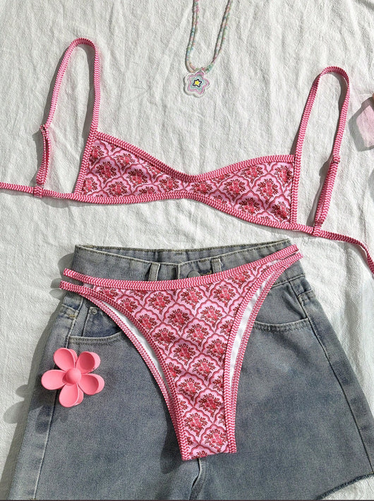 Black bandeau bikini swimsuit with thin straps and a gold-toned abstract ring detail on the top, paired with matching string bottoms. - Image 10