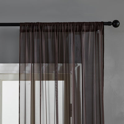 Sheer pink rod pocket curtain hanging on a black curtain rod, offering light transmission for a modern room. - Image 10