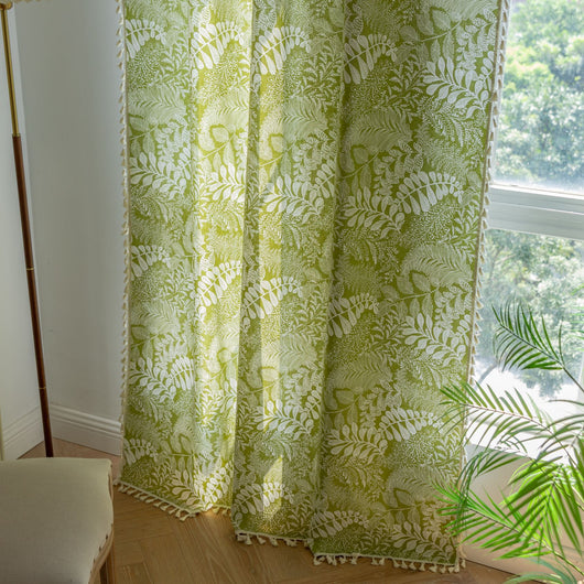 Green curtain with white leafy botanical pattern and cream tassels, hanging in a window with natural light. - Image 19
