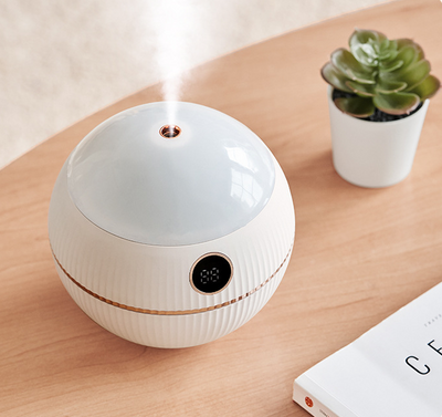 Pink spherical humidifier with a white top, ribbed texture, rose gold band, and a digital display showing 73%. - Image 8