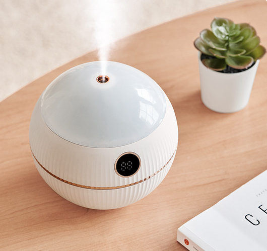 Pink spherical humidifier with a white top, ribbed texture, rose gold band, and a digital display showing 73%. - Image 8