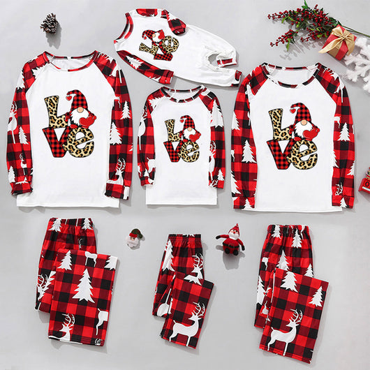 Matching family Christmas pajamas in red and black plaid with "Merry Christmas" text, tree, and reindeer prints. - Image 14