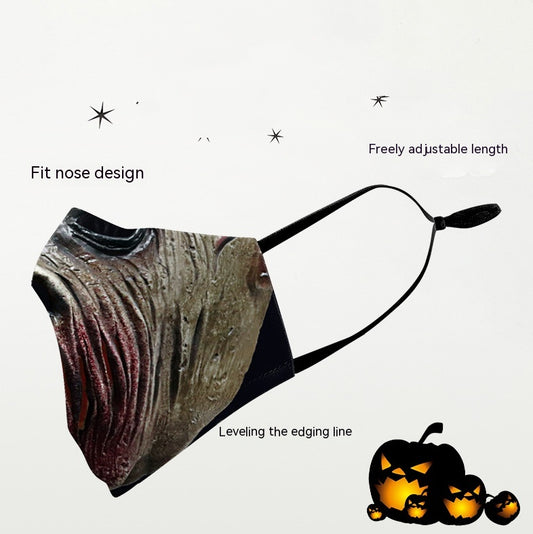 Green and yellow digital print Halloween dust mask with a grotesque, tree-like face design and black ear loops. - Image 2