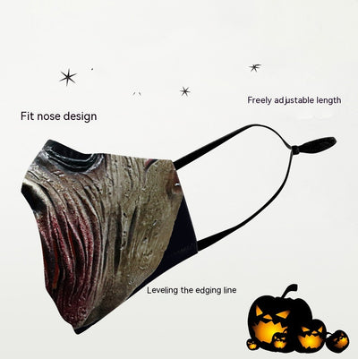 Green and yellow digital print Halloween dust mask with a grotesque, tree-like face design and black ear loops. - Image 2