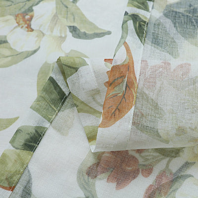 Dark gray semi-sheer curtains with a white and green floral pattern, hung on a black rod in a living room. - Image 6