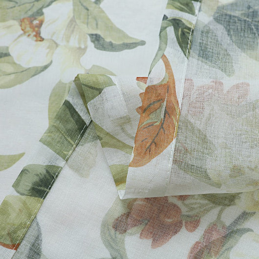 Dark gray semi-sheer curtains with a white and green floral pattern, hung on a black rod in a living room. - Image 6