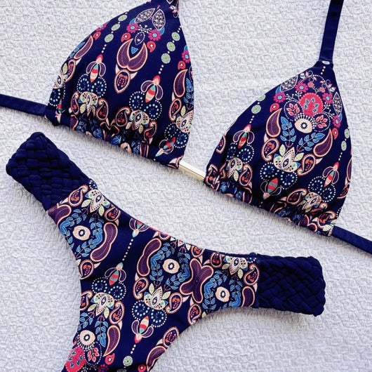 Women's blue, white, and gold marble print bikini with a triangle halter top and braided rope side details.