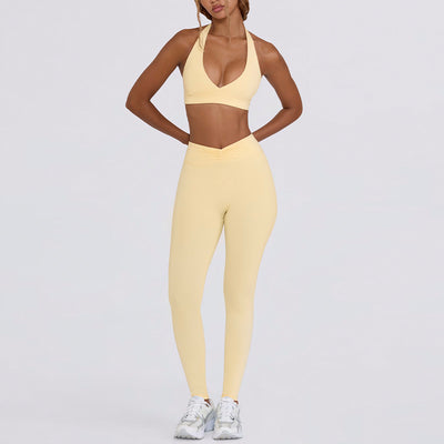 Light pink halter neck sports bra and high-waisted leggings workout set on a model. - Image 18