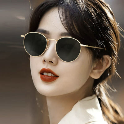Round red lens sunglasses with a gold metal frame and black temple tips on a white background. - Image 15