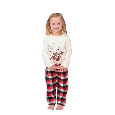 Family of four and a golden retriever wearing matching white long-sleeve reindeer tops and red plaid pajama pants. - Image 19
