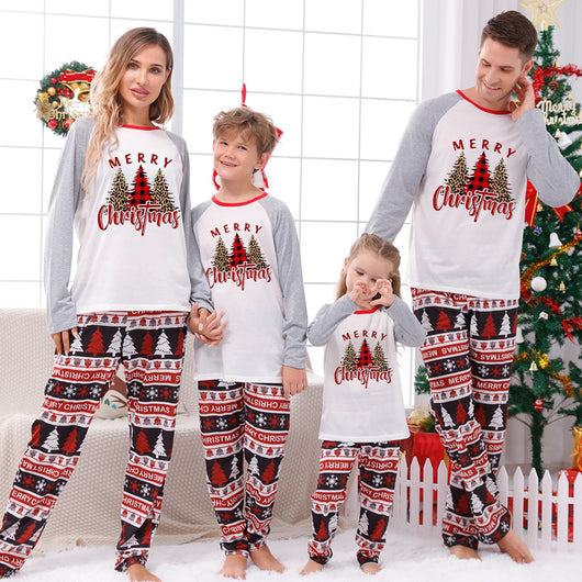 Family of four wearing matching Christmas pajamas with 'MERRY Christmas' text, leopard print, and plaid trees. - Image 2