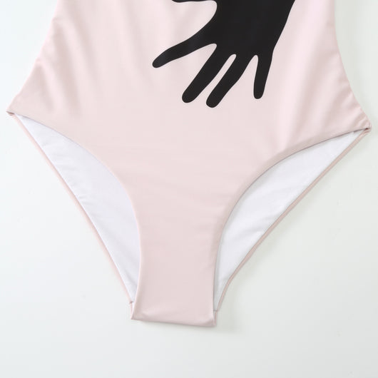 Women's light pink one-piece bikini with black handprint pattern and matching tie-waist sarong. - Image 8