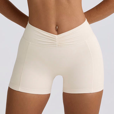Light pink halter neck sports bra and high-waisted leggings workout set on a model. - Image 21