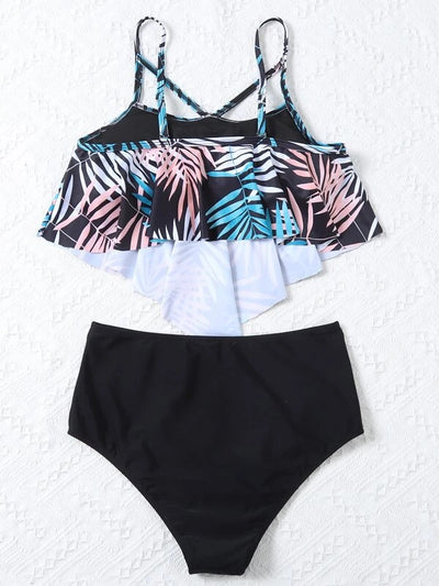 Women's split swimsuit with a black high-waisted bikini bottom and a flounced tankini top featuring a green, blue, and white tropical leaf print. - Image 23