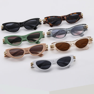 Black cat-eye sunglasses with dark gray lenses and gold-tone hinge accents on a white background.