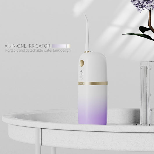 White and rose gold portable electric water flosser with a curved nozzle and volume markings for 160ml and 200ml. - Image 3