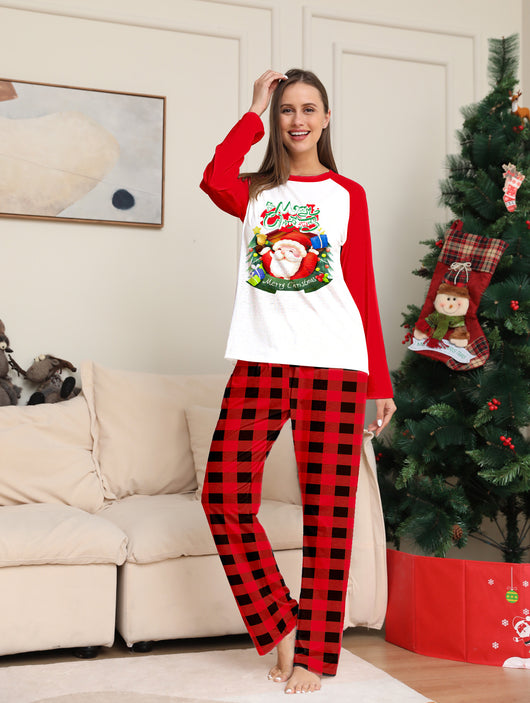 Man in a red and white Christmas pajama set with a Santa Claus graphic top and red and black plaid pants. - Image 7