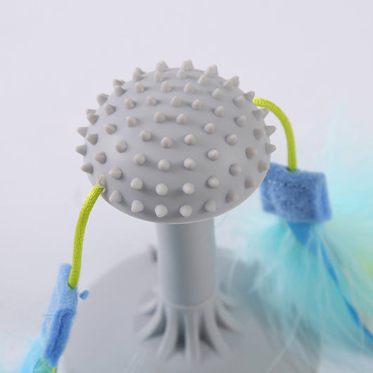 Gray suction cup cat toy with a textured top and two blue and yellow feathered wands attached by green cords. - Image 3