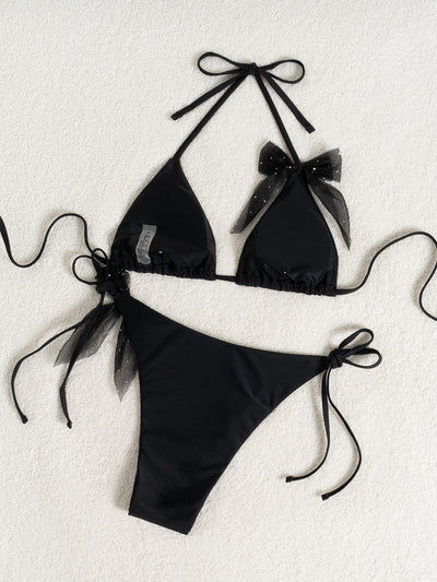 Black strappy backless bikini two-piece swimsuit for women with triangle top and tie-side bottoms, featuring sheer polka dot bows. - Image 16