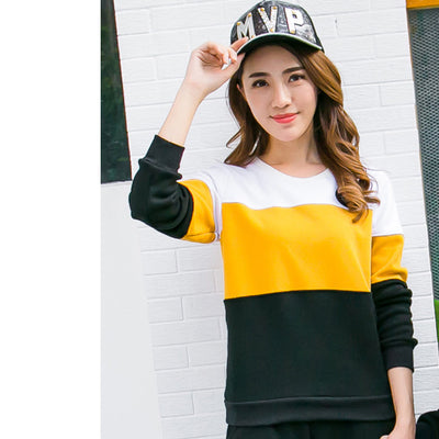 Men's white and yellow color block long-sleeve top with a crew neck and circular embroidered patch on the chest. - Image 9