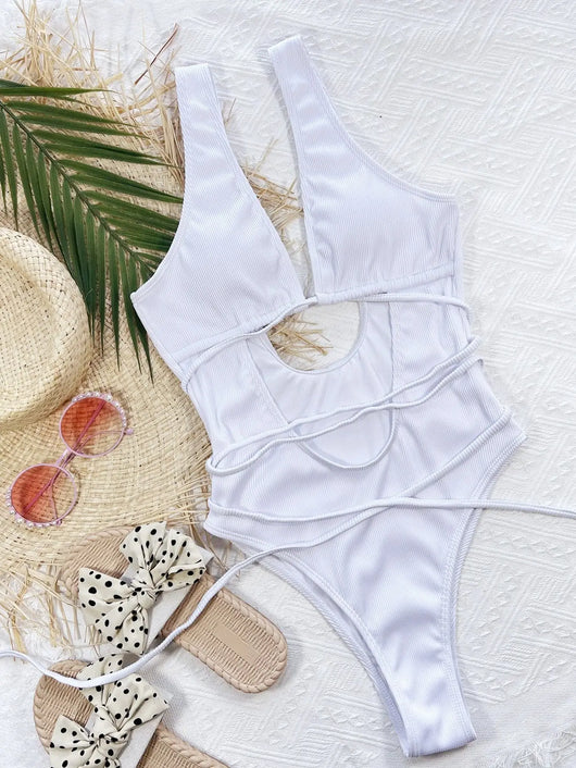 White ribbed one-piece swimsuit with deep V-neck, hollow cut-outs, and criss-cross tie straps. - Image 16