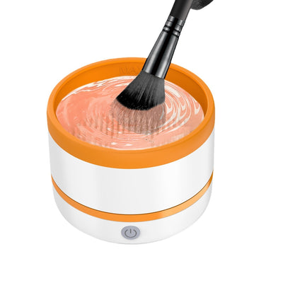 Automatic makeup brush cleaning device in white and light blue, actively cleaning a dark makeup brush. - Image 5