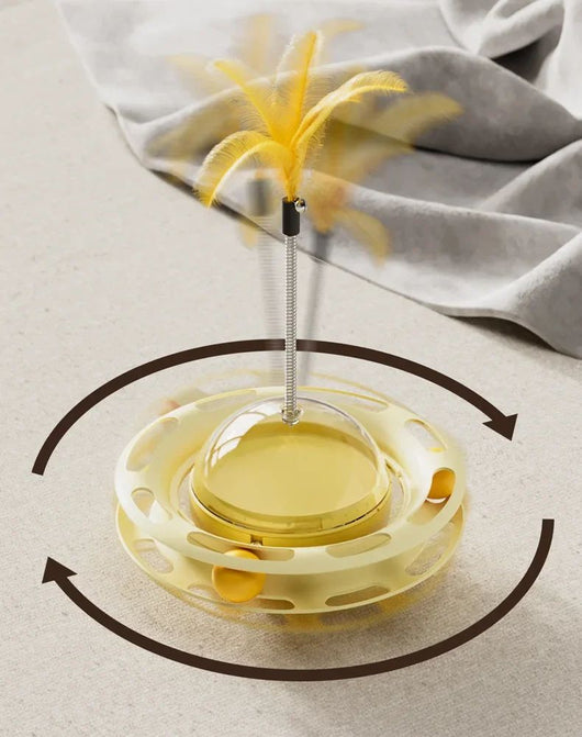 Yellow UFO tumbler cat toy with rolling balls, a clear dome, and a spring-mounted feather wand with a bell. - Image 10