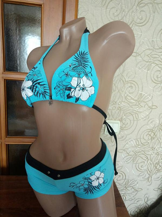 Black halter bikini suit with boy short bottoms, featuring pink and blue floral and flamingo patterns. - Image 6