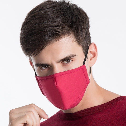 Young man wearing a black cotton face mask with adjustable ear loops, suitable for warmth and dust protection. - Image 4