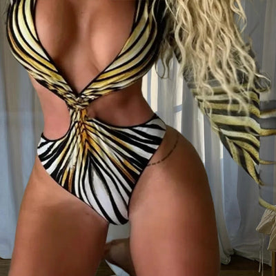 Woman in a teal, black, and white tropical print one-piece swimsuit with deep V-neck, cut-outs, and matching kimono cover-up. - Image 3