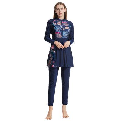 Woman in a navy blue quick-drying conservative swimwear set with a tropical leaf print tunic and matching swim cap. - Image 22