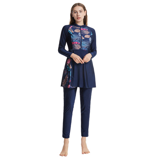 Woman in a navy blue quick-drying conservative swimwear set with a tropical leaf print tunic and matching swim cap. - Image 22